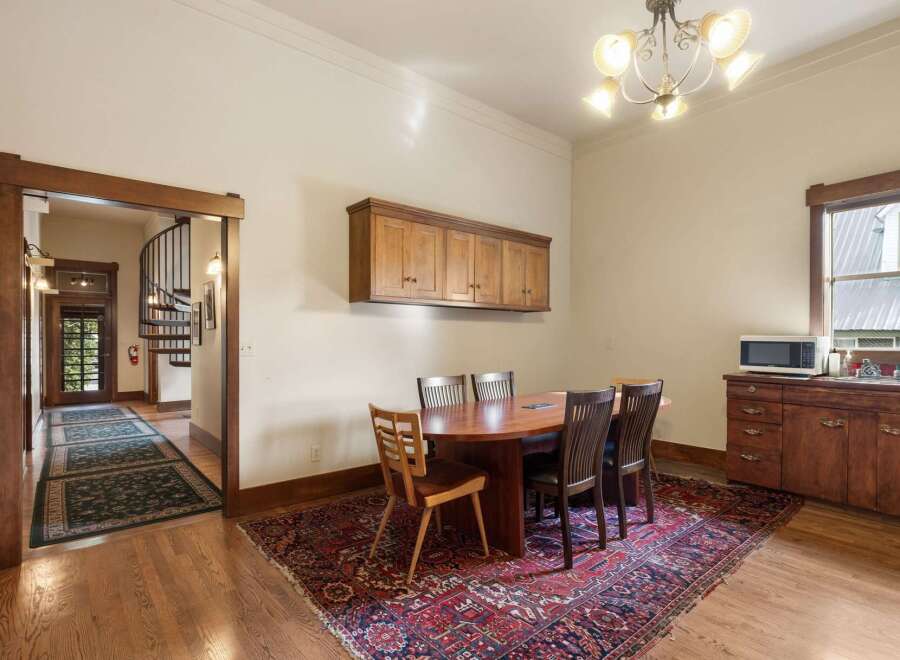 Step into this charming dining area, featuring a beautiful oval wood table surrounded by four elegant chairs, perfect for intimate gatherings.