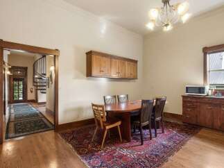 Step into this charming dining area, featuring a beautiful oval wood table surrounded by four elegant chairs, perfect for intimate gatherings.