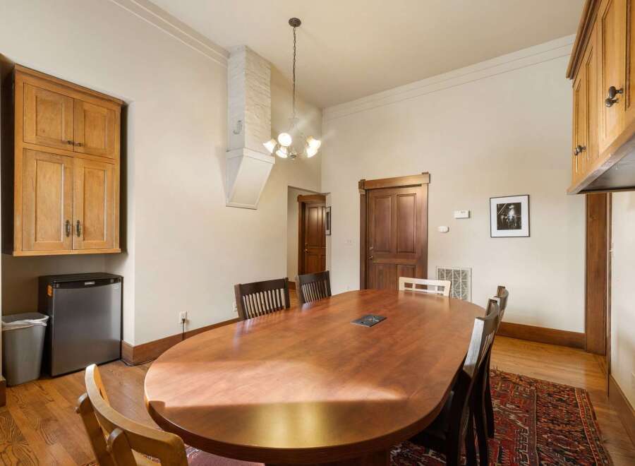 This dining room features a large, polished wooden oval table, perfect for gatherings.