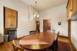 This dining room features a large, polished wooden oval table, perfect for gatherings.