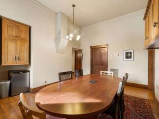 This dining room features a large, polished wooden oval table, perfect for gatherings.