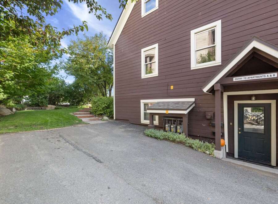 Discover this charming property featuring a well-maintained exterior with rich brown siding and classic white trim.
