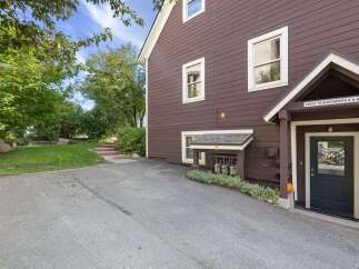 Discover this charming property featuring a well-maintained exterior with rich brown siding and classic white trim.