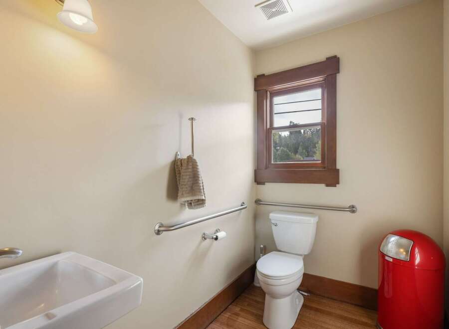 This accessible bathroom features a white toilet with grab bars for added safety and convenience.