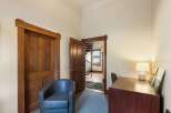 Step into this charming space featuring a comfortable armchair and a functional desk area, perfect for a home office or reading nook.