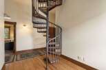 Ascend to new heights in this charming home featuring a stunning spiral staircase.