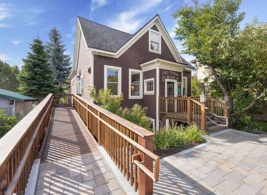 Discover the charm of Old Tonini House, a beautifully maintained property featuring a welcoming wooden ramp and accessible entrance.