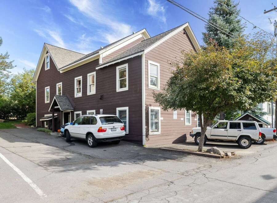 Discover this charming property featuring a multi-story brown building with ample parking space.