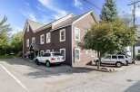 Discover this charming property featuring a multi-story brown building with ample parking space.