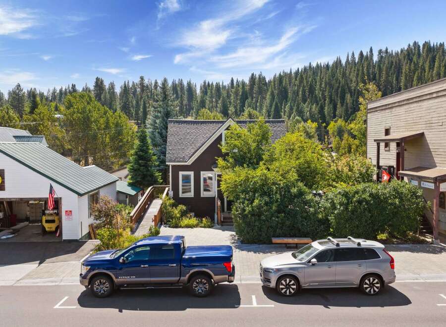 Discover this charming property nestled amidst a lush forest backdrop, offering a unique blend of residential and commercial potential.