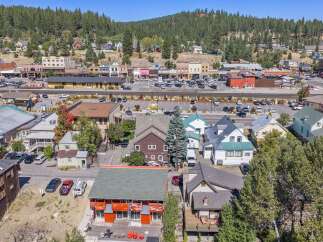 Discover this charming property nestled in a vibrant mountain town, offering a unique blend of residential living and commercial potential.