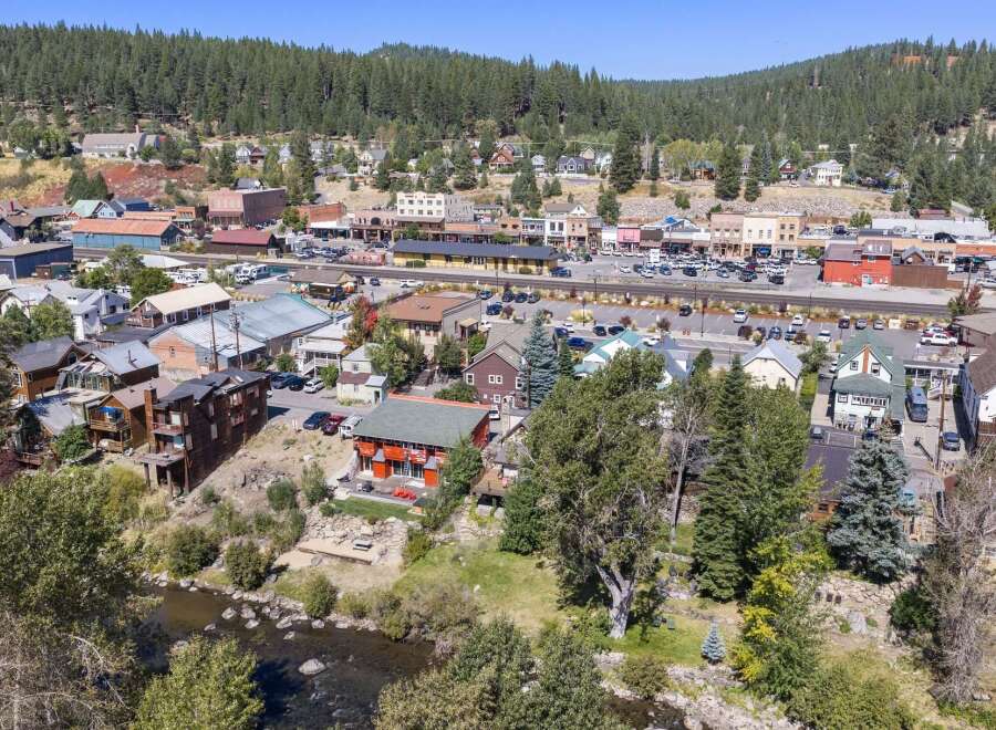 Discover this charming property nestled beside a serene river, offering breathtaking mountain and town views.