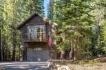 Nestled amidst towering pine trees, this charming mountain home offers a serene escape.