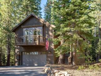 Nestled amidst towering pine trees, this charming mountain home offers a serene escape.