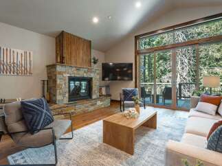 Experience cozy living in this mountain retreat, featuring a stunning stone fireplace as the centerpiece of the living room.