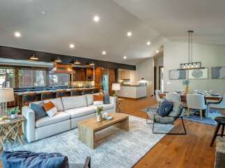 Experience luxury living in this stunning open-concept home, featuring a gourmet kitchen with rich wood cabinetry and a spacious island perfect for entertaining.