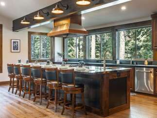 Experience luxury mountain living in this stunning kitchen, featuring a large island with bar seating perfect for entertaining.