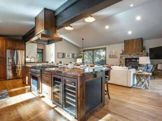 Experience luxury mountain living in this stunning open-concept home, featuring a gourmet kitchen with a large island, wine fridge, and professional-grade appliances.