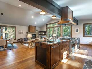 Experience luxury mountain living in this stunning open-concept home, featuring a gourmet kitchen with a large island and high-end appliances.