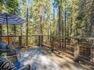 Enjoy the serene mountain setting from this charming deck, perfect for outdoor relaxation.