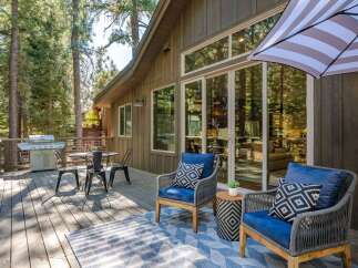Enjoy outdoor living on this spacious wooden deck, perfect for entertaining or relaxing amidst nature.