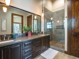 Experience luxury in this stunning bathroom featuring a spacious double vanity with ample storage and elegant fixtures.