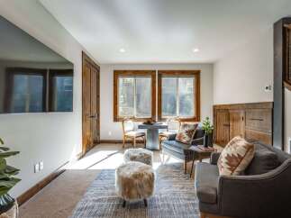 This cozy living area features a large flat-screen TV mounted on the wall, perfect for entertainment.