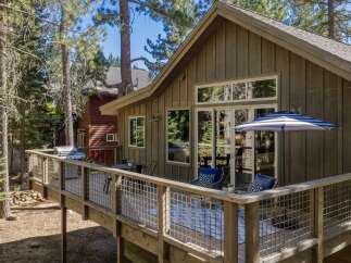 Enjoy outdoor living on this spacious deck, perfect for entertaining or relaxing amidst the trees.