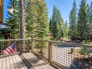 Enjoy the serene mountain setting from this charming deck, complete with an American flag accent.