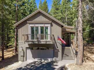 Nestled among tall pine trees, this modern mountain home offers a serene retreat.