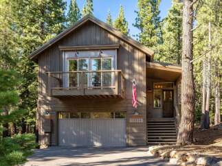 Nestled amongst towering pine trees, this charming mountain home offers a perfect blend of rustic appeal and modern comfort.