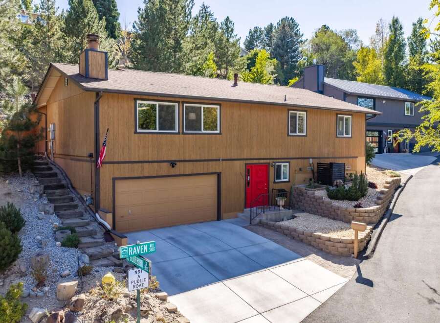 Discover this charming home featuring a warm brown exterior and a striking red front door, offering immediate curb appeal.