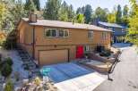 Discover this charming home featuring a warm brown exterior and a striking red front door, offering immediate curb appeal.