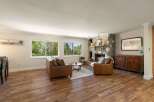Experience cozy living in this inviting living room, featuring a stunning stone fireplace perfect for chilly evenings.
