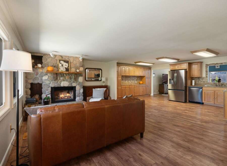 Experience comfortable living in this spacious open-concept home featuring a stunning stone fireplace as the centerpiece of the living area.