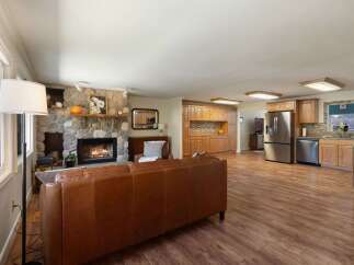 Experience comfortable living in this spacious open-concept home featuring a stunning stone fireplace as the centerpiece of the living area.