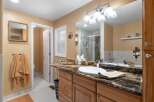 Step into this beautifully updated bathroom featuring a spacious vanity with a granite countertop and a large undermount sink.