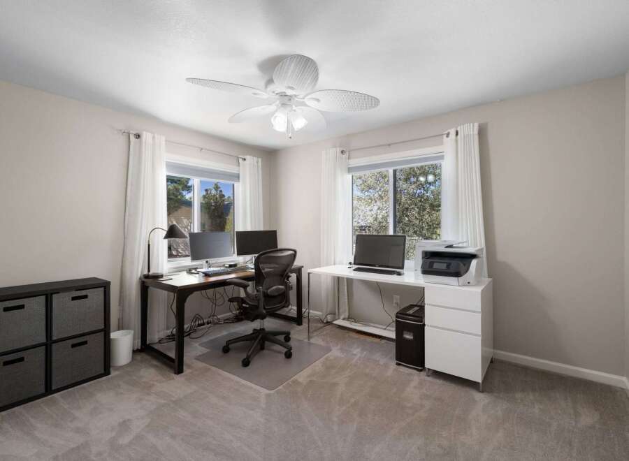 This home office features two distinct workstations, perfect for a shared workspace or dual home offices.