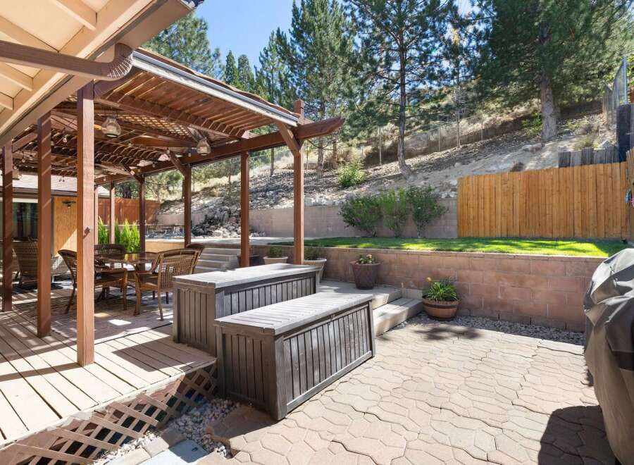 Enjoy outdoor living with this spacious backyard featuring a covered patio and a paved entertainment area.