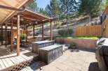 Enjoy outdoor living with this spacious backyard featuring a covered patio and a paved entertainment area.