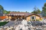 Enjoy outdoor living with this charming home featuring a spacious pergola-covered patio perfect for entertaining.