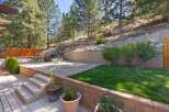 Discover this stunning backyard oasis featuring a multi-level design with a spacious deck and a charming patio area.