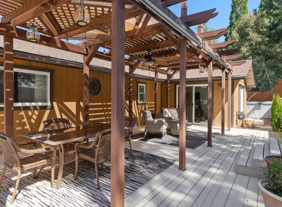 Enjoy outdoor living with this spacious deck featuring a covered pergola, perfect for al fresco dining and relaxation.