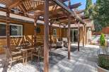 Enjoy outdoor living with this spacious deck featuring a covered pergola, perfect for al fresco dining and relaxation.