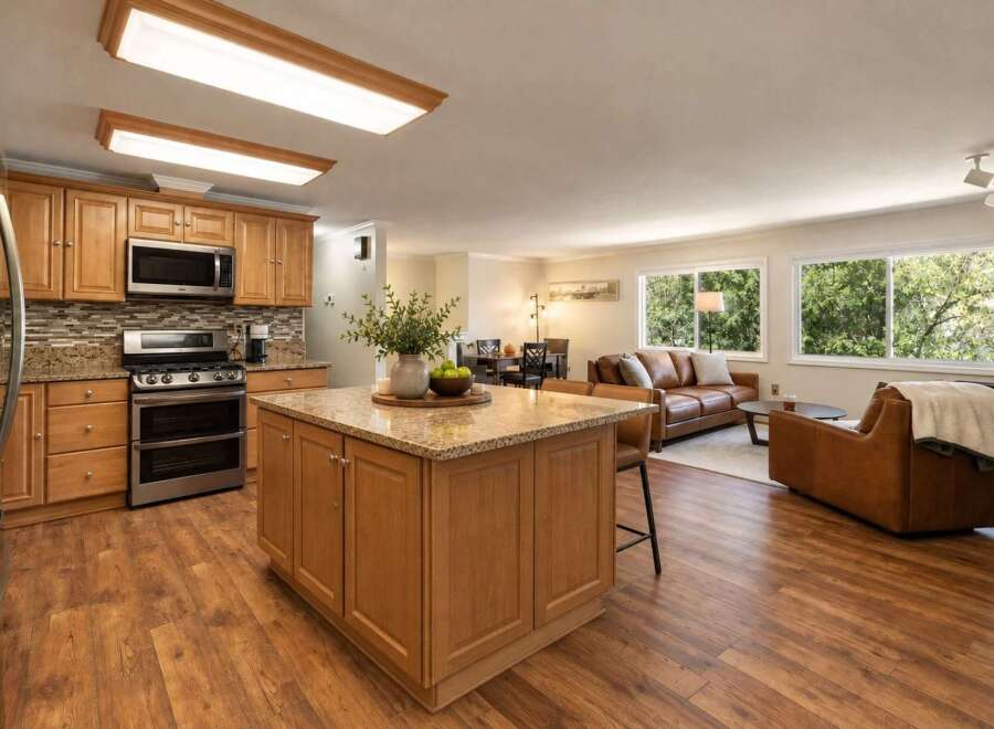 This open-concept living space seamlessly blends a modern kitchen with a comfortable living area, perfect for entertaining.