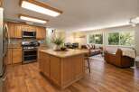 This open-concept living space seamlessly blends a modern kitchen with a comfortable living area, perfect for entertaining.