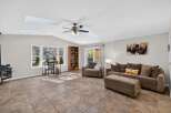 This spacious living room features a vaulted ceiling with skylights, flooding the space with natural light.