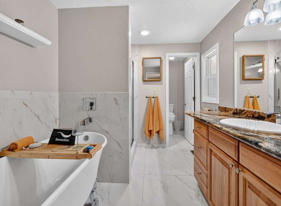 Indulge in luxury with this stunning bathroom featuring a freestanding bathtub perfect for a relaxing soak.