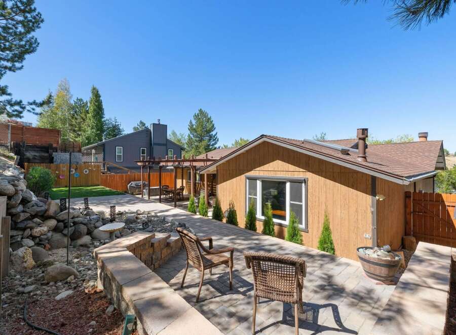 Enjoy outdoor living in this beautifully landscaped backyard featuring a spacious paver patio perfect for entertaining.