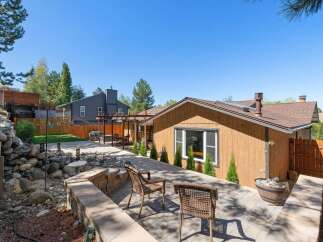 Enjoy outdoor living in this beautifully landscaped backyard featuring a spacious paver patio perfect for entertaining.